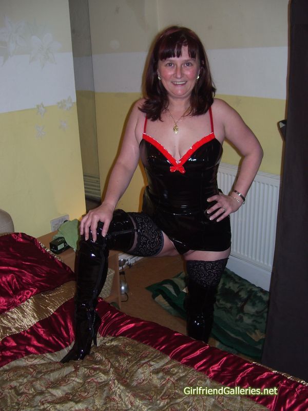 Slut wife Dec in Pvc dress and boots with black stockings