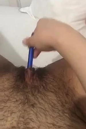 Arabic slut fingering herself with a pen