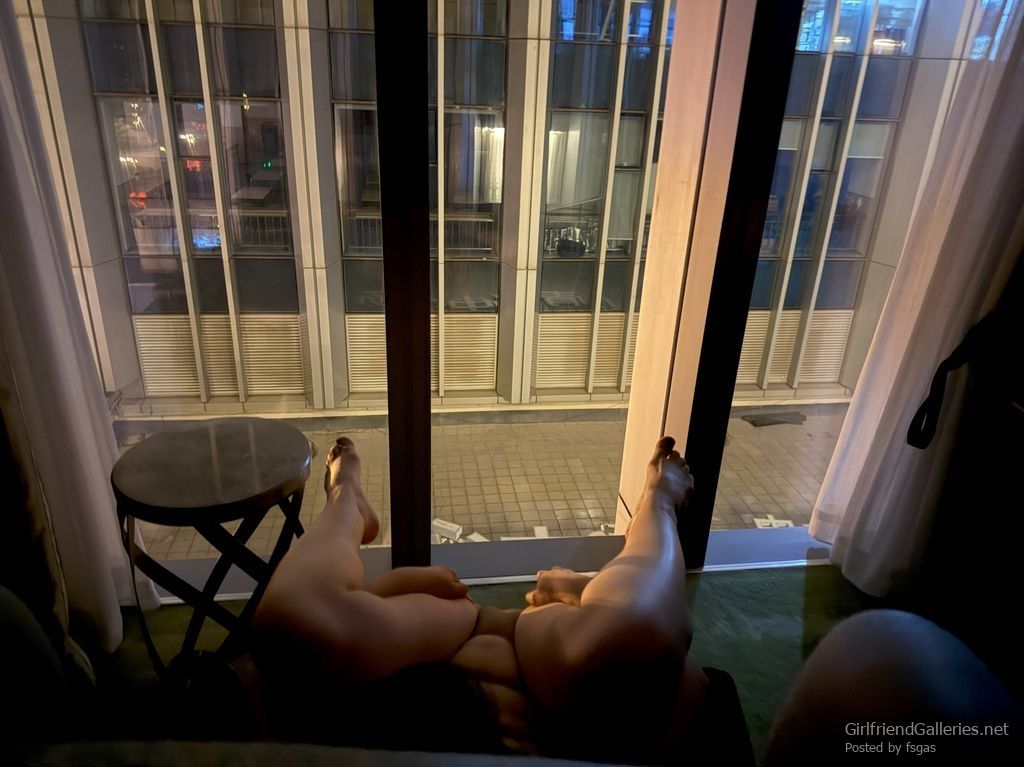 Slutty Lulu exposes her pussy in front of the window